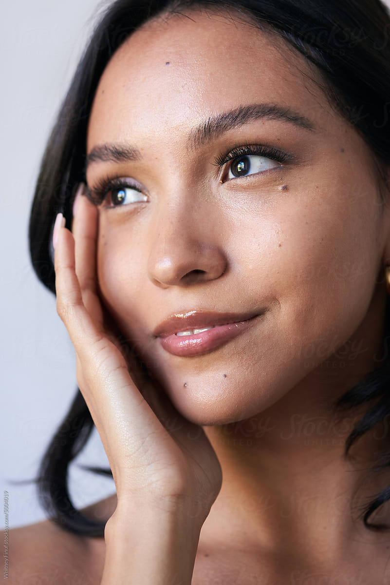 A women is smiling after skin care